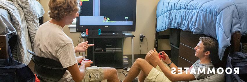 两个男生在宿舍里玩电子游戏.